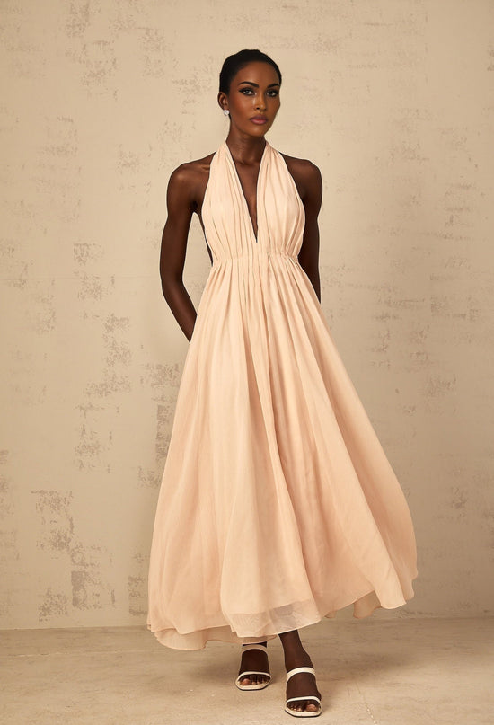 Teresa Maxi Dress in Peach Pink and Neutrals halter-neck shirred tulle open back design cinched waist 100% Terylene fiber rear tie zip fastening special occasions