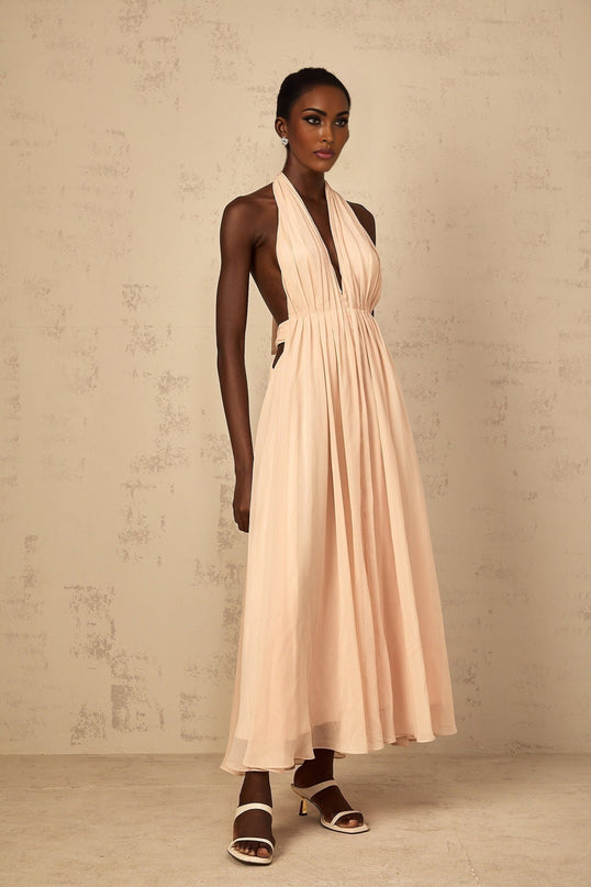 Teresa Maxi Dress in Peach Pink Neutrals halter-neck shirred tulle open back design cinched waist 100% Terylene fiber rear tie zip fastening special occasions