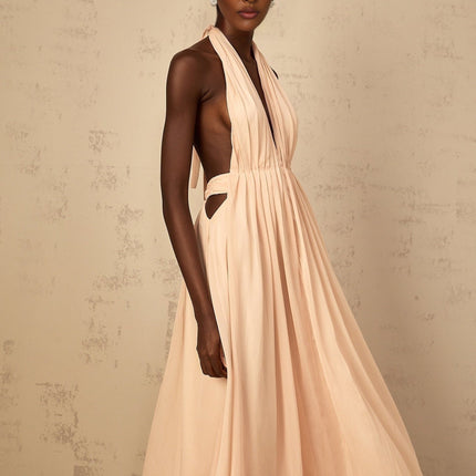 Teresa Maxi Dress in Peach Pink and Neutrals halter-neck silhouette shirred tulle fabric open back design maxi length cinched waist 100% Terylene fiber intricate detailing rear tie zip fastening special occasions