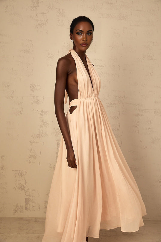 Teresa Maxi Dress in Peach Pink and Neutrals halter-neck silhouette shirred tulle fabric open back design maxi length cinched waist 100% Terylene fiber intricate detailing rear tie zip fastening special occasions