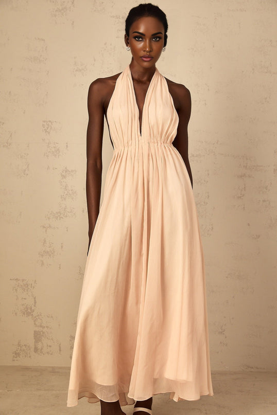 Teresa Maxi Dress in Peach Pink and Neutrals halter-neck silhouette shirred tulle fabric open back design modern elegance maxi length cinched waist 100% Terylene fiber intricate detailing rear tie zip fastening special occasions statement