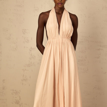 Teresa Maxi Dress in Peach Pink and Neutrals halter-neck silhouette shirred tulle fabric open back design maxi length cinched waist 100% Terylene fiber intricate detailing rear tie zip fastening special occasions