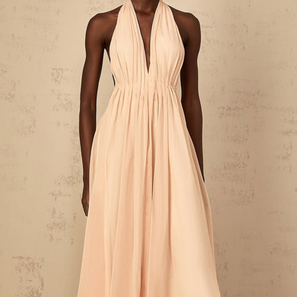 Teresa Maxi Dress in Peach Pink and Neutrals halter-neck silhouette shirred tulle open back design maxi length cinched waist 100% Terylene fiber intricate detailing rear tie zip fastening special occasions