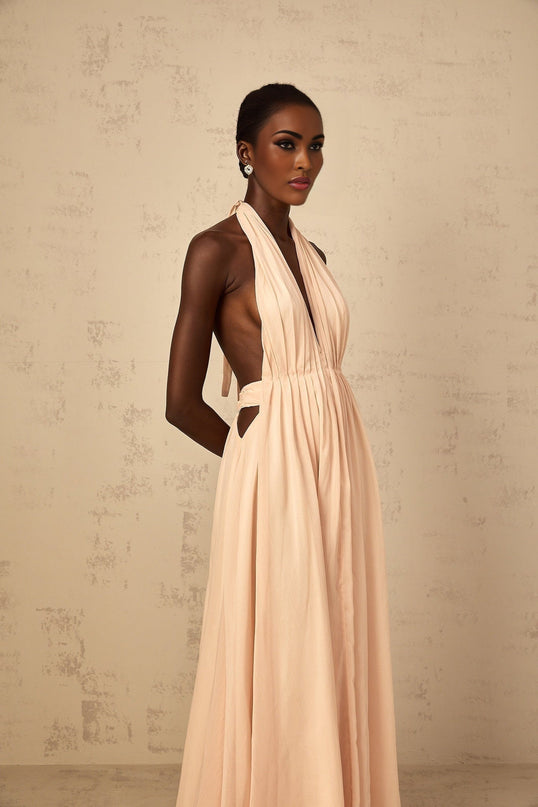 Teresa Maxi Dress in Peach Pink and Neutrals halter-neck silhouette shirred tulle open back design cinched waist 100% Terylene fiber rear tie zip fastening special occasions