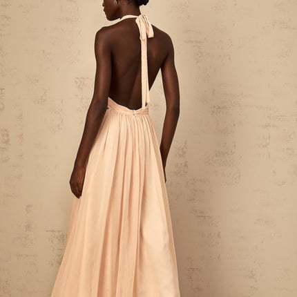 Teresa Maxi Dress in Peach Pink and Neutrals halter-neck silhouette shirred tulle fabric open back design maxi length cinched waist 100% Terylene fiber intricate detailing rear tie zip fastening special occasions