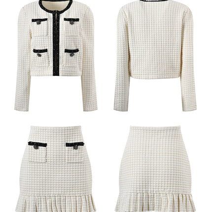 Textured white knitted jacket with black trim and decorative buttons paired with a ruffled hem skirt