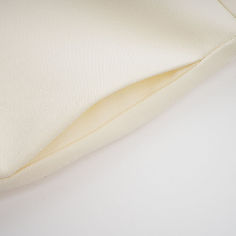 Two piece womens outfit in neutral tones featuring a top and skirt with 3D flower petal details for a textured look