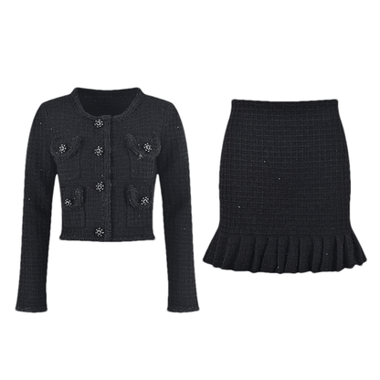 A black waffleknit dress with a pleated thighlength skirt made of 80% Polyester and 20% Cotton
