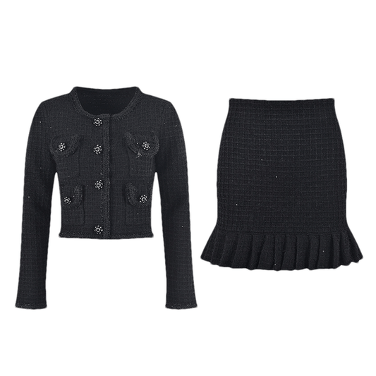 A black waffleknit dress with a pleated thighlength skirt made of 80% Polyester and 20% Cotton