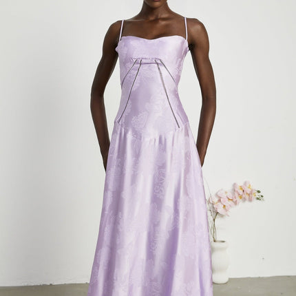 Valerie in Purple Seraphina Jacquard Maxi Dress Spaghetti Strap Low-Cut Neckline Jacquard Fabric Side Zip Fastening Rear Tie Fastening Maxi Length Design Sizes Available Effortless Glamour