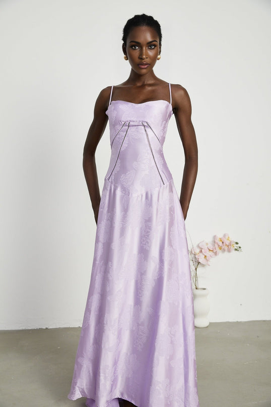 Valerie in Purple Seraphina Jacquard Maxi Dress Spaghetti Strap Low-Cut Neckline Jacquard Fabric Side Zip Fastening Rear Tie Fastening Maxi Length Design Sizes Available Effortless Glamour
