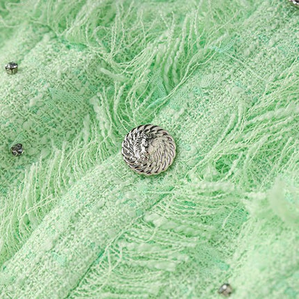 Vibrant mint green halter neck dress with rhinestone accents and textured fabric