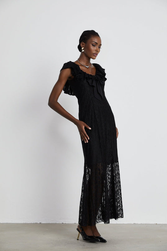 Virginia Black Chantilly Lace Gown Bow Trim Slip Dress Model 5'10 Size M V-Neckline Ruffled Trim Semi-Sheer Detachable Slip Dress Rear Hook Zip Fastening 50% Polyester 50% Viscose