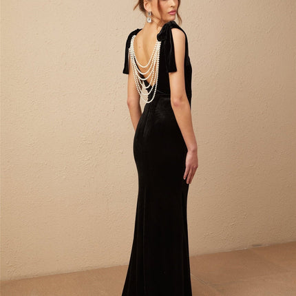 Vittoria Black Velvet Maxi Dress with Cowl Neck and Open Back Bow detail adorned with Faux-Pearls