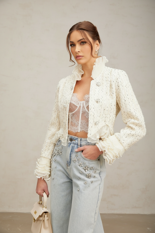 Woman wearing white cropped jacket with beaded embellishments and ruffle details on sleeves and collar | Hair Updated