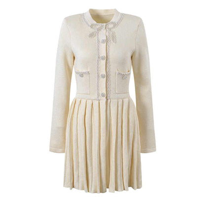 White A-line silhouette with fitted bodice button-down pleated skirt tailored for a flattering shape elegant sophisticated look lightweight knitted fabric embellished buttons pockets suitable for formal events classic contemporary style