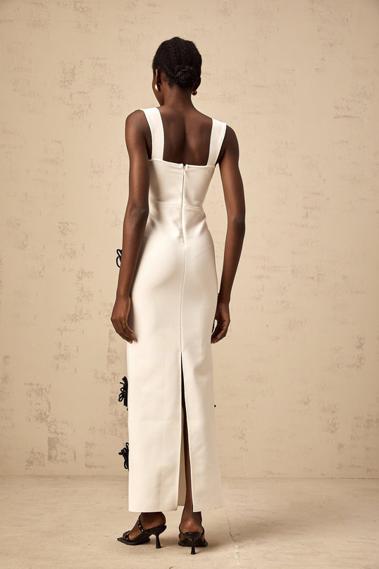 White bandage maxi dress with floral applique details named Olivia