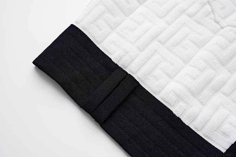 White and black military-inspired cropped jacket with gold-tone buttons and textured fabric