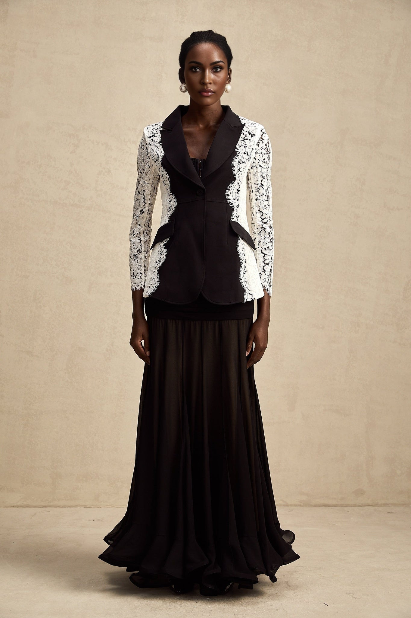 White blazer with contrasting black panels and lace trim details