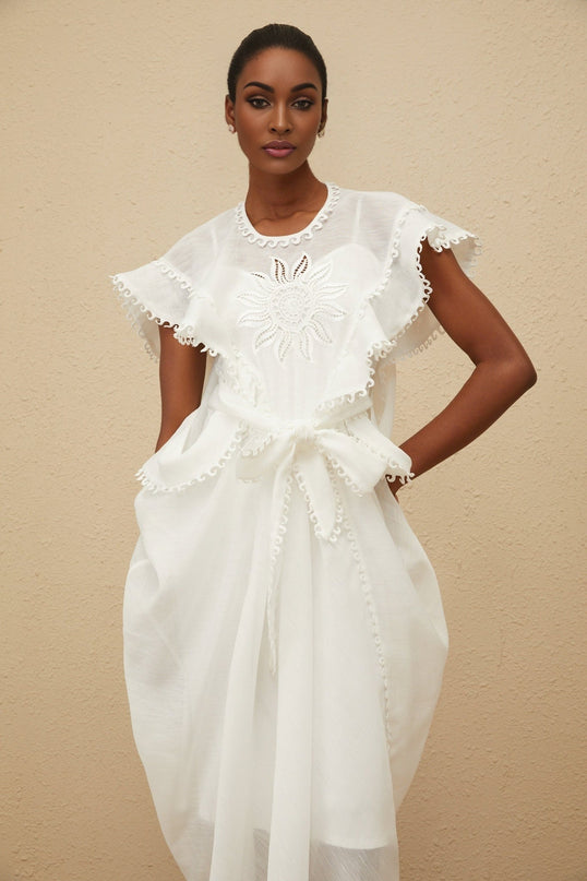 White cotton maxi dress with floral embroidery and tied waist