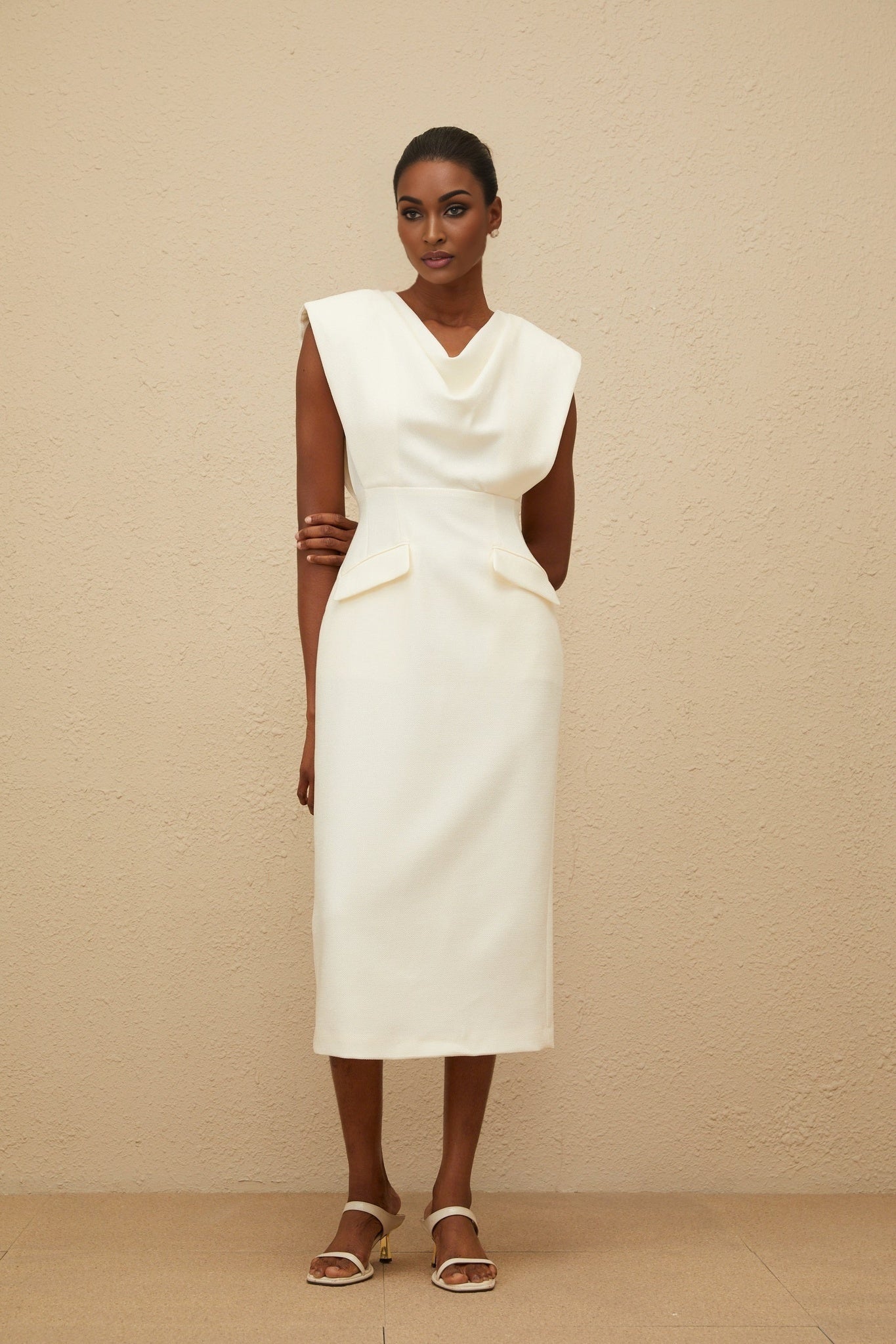 White cowl neck cap sleeve pencil silhouette dress with faux pocket detailing and rear slit