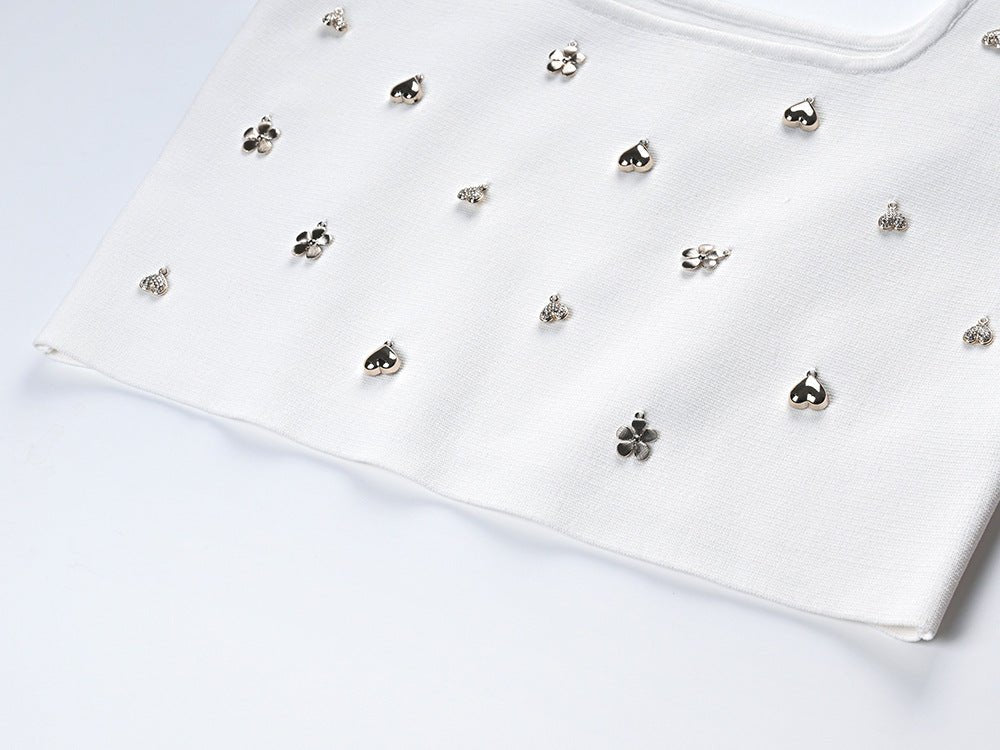 White cropped top with flared skirt embellished with floral motifs