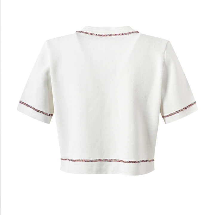 White cropped top and high-waisted skirt with contrast trim and pockets