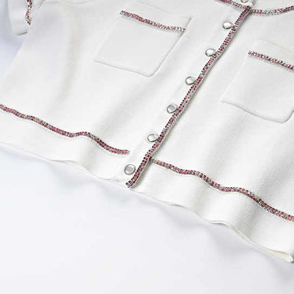 White cropped top and high-waisted skirt with button-up design and pocket details