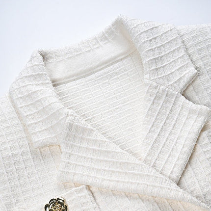 White double-breasted blazer and skirt set with gold accents