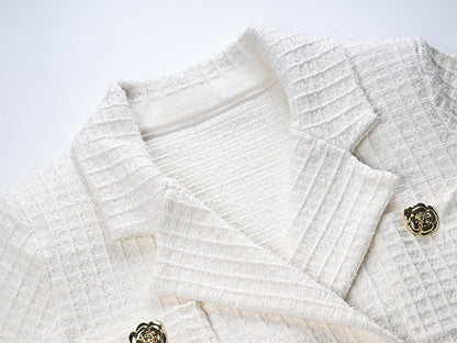 White double-breasted blazer and skirt set with gold accents