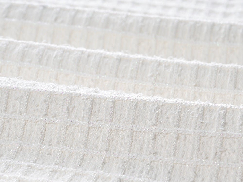 White double-breasted cropped blazer with fitted skirt and gold accents