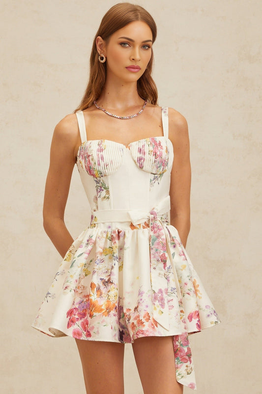 White floral print sweetheart neckline dress with cinched waist and flounce skirt