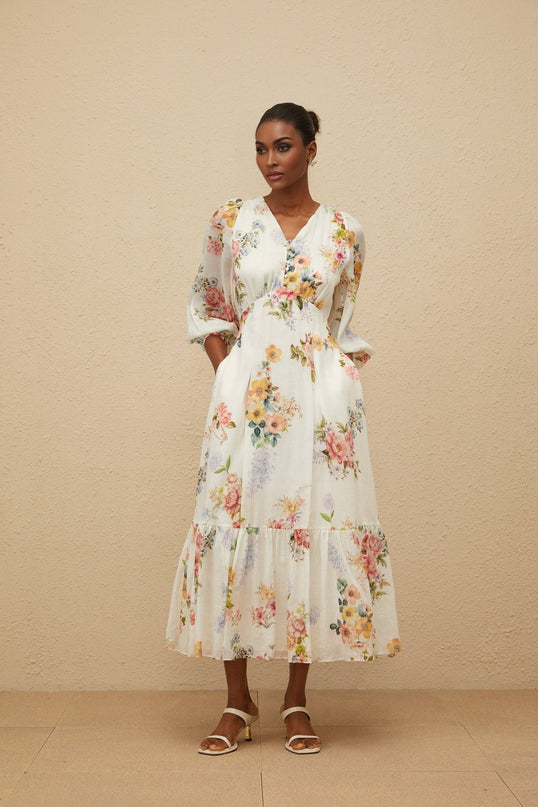 White floral print V-neck maxi dress with long puff sleeves and fitted waistline