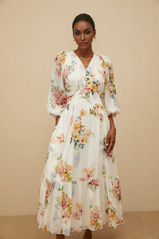 White floral print V-neck maxi dress with long puff sleeves and fitted waistline