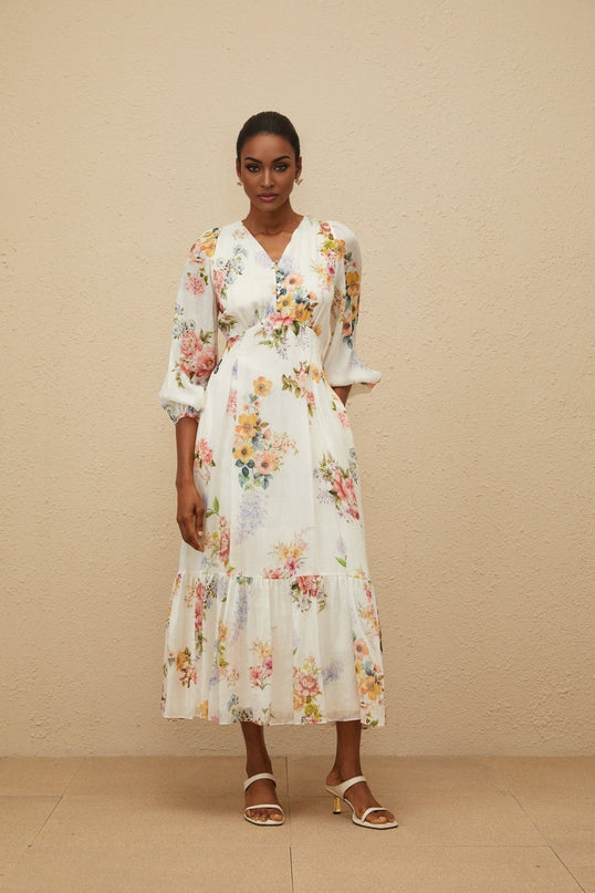 White floral print V-neck maxi dress with long puff sleeves and fitted waistline