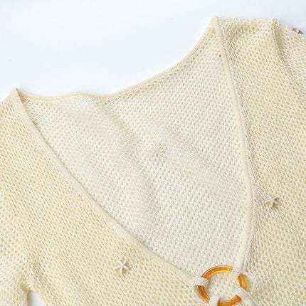 White form-fitting knit top with circular accent at bust