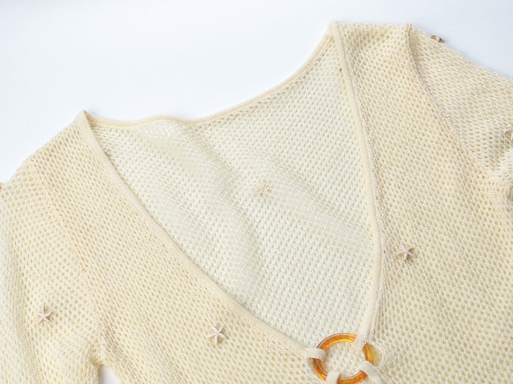 White form-fitting knit top with circular accent at bust