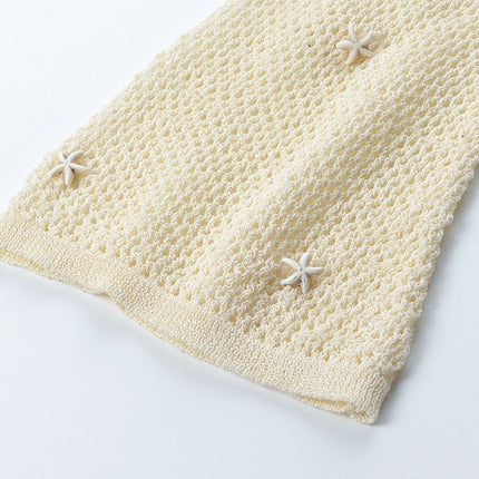 White form-fitting V-neckline knit top with circular accent