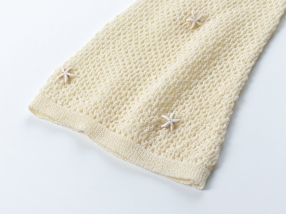 White form-fitting V-neckline knit top with circular accent