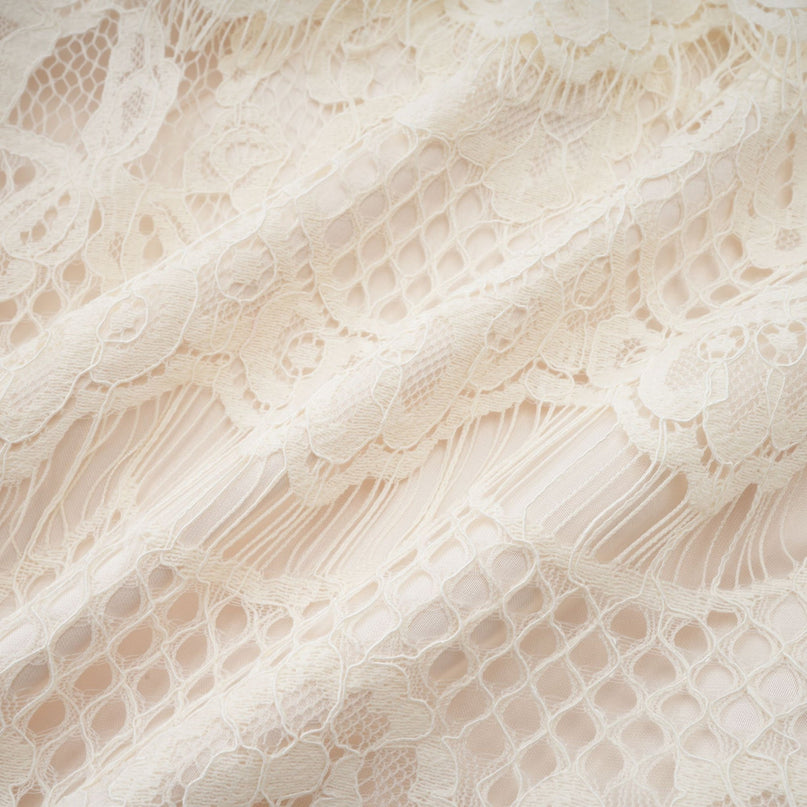 White lace blouse with bow detail and floral pattern