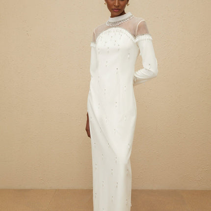 White long sleeve maxi dress with cinched waist, tulle panelling, faux-pearl and rhinestone embellishment, rear slit, and rear zip fastening