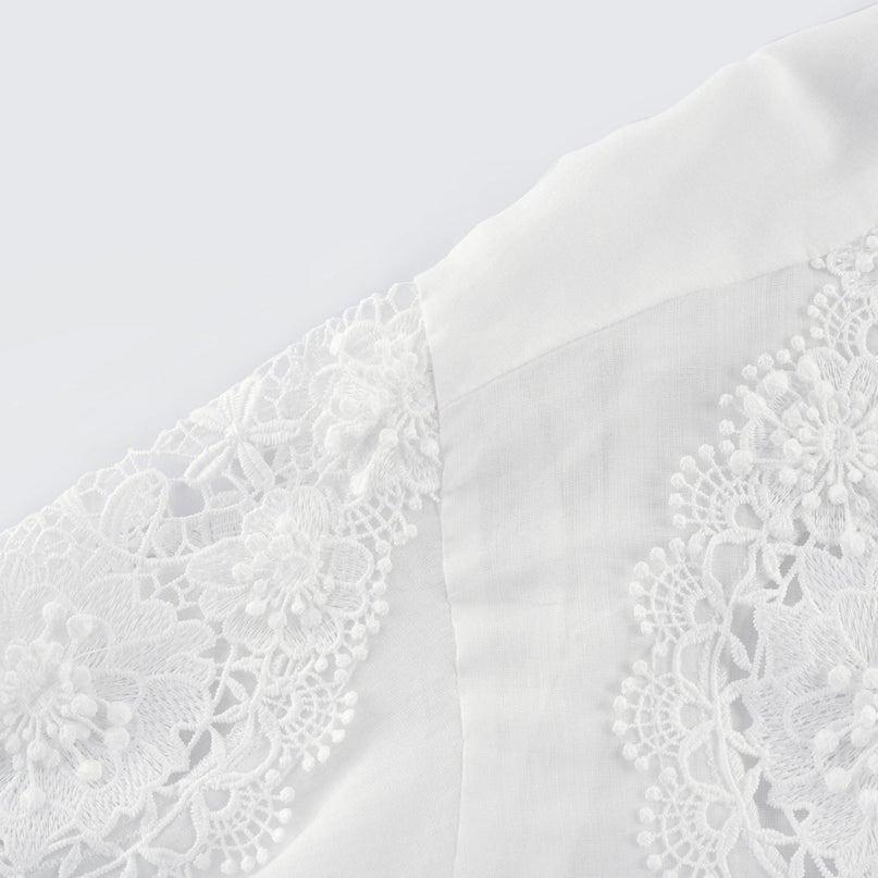 White long sleeve shirt with lace embroidery detailing and cut out design on shoulders