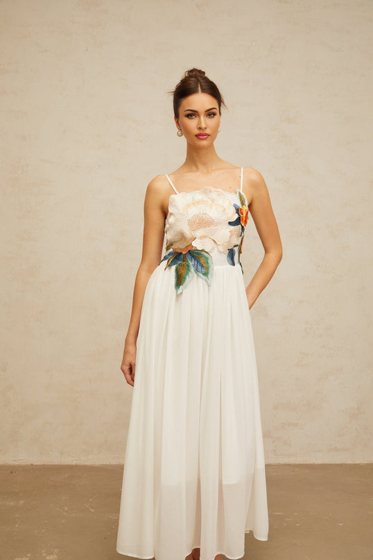 White maxi dress with floral embroidery and shirred details named Josette