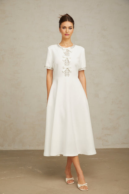 White midi dress with crystal accents and bow detail named Cassiopeia