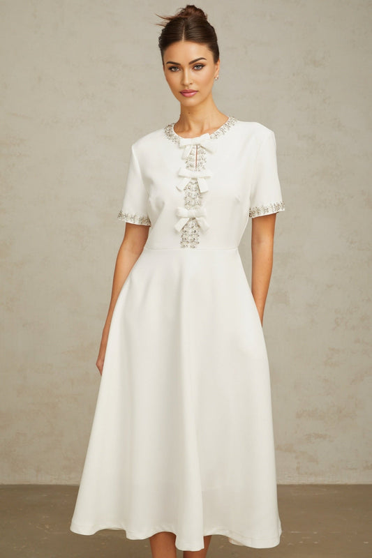 White midi dress with crystal accents and bow detail named Cassiopeia