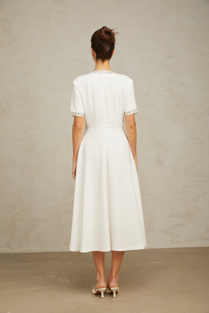 White midi dress with crystal accents and bow detail named Cassiopeia