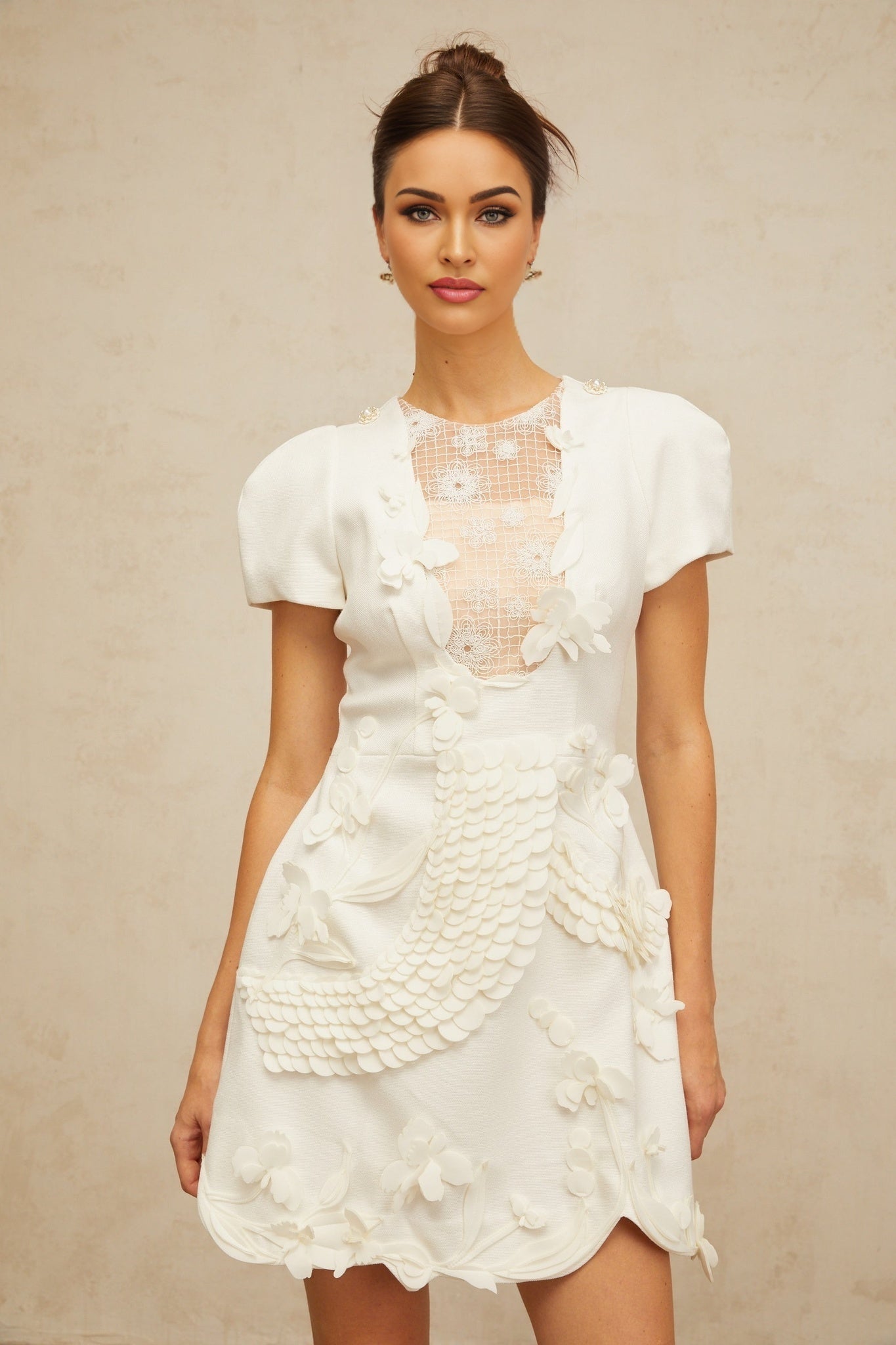 White mini dress with puffed sleeves and floral applique details named Frida