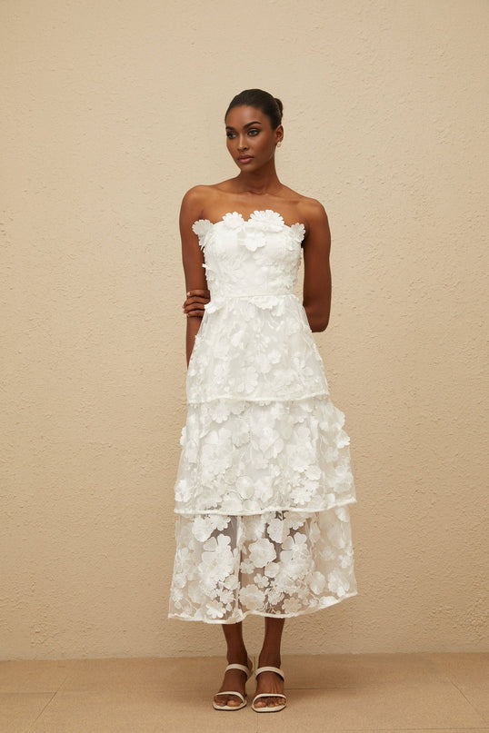 White off the shoulder sleeveless dress with 3D-petal and floral embroidered detailing, cinched waist, tiered skirt, and rear zip fastening