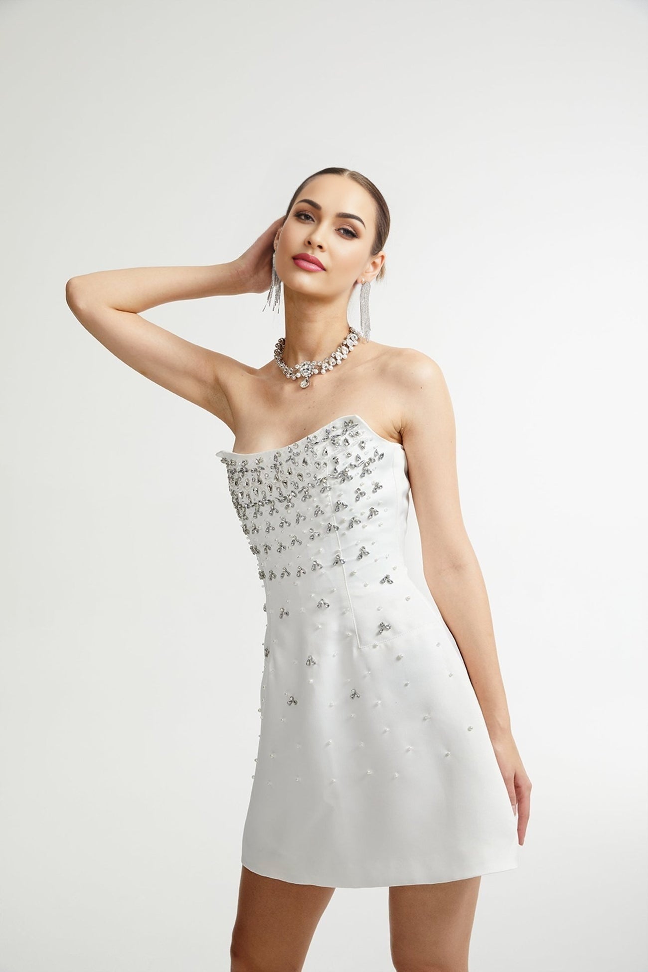 White ornate mini dress named Melisande with decorative details