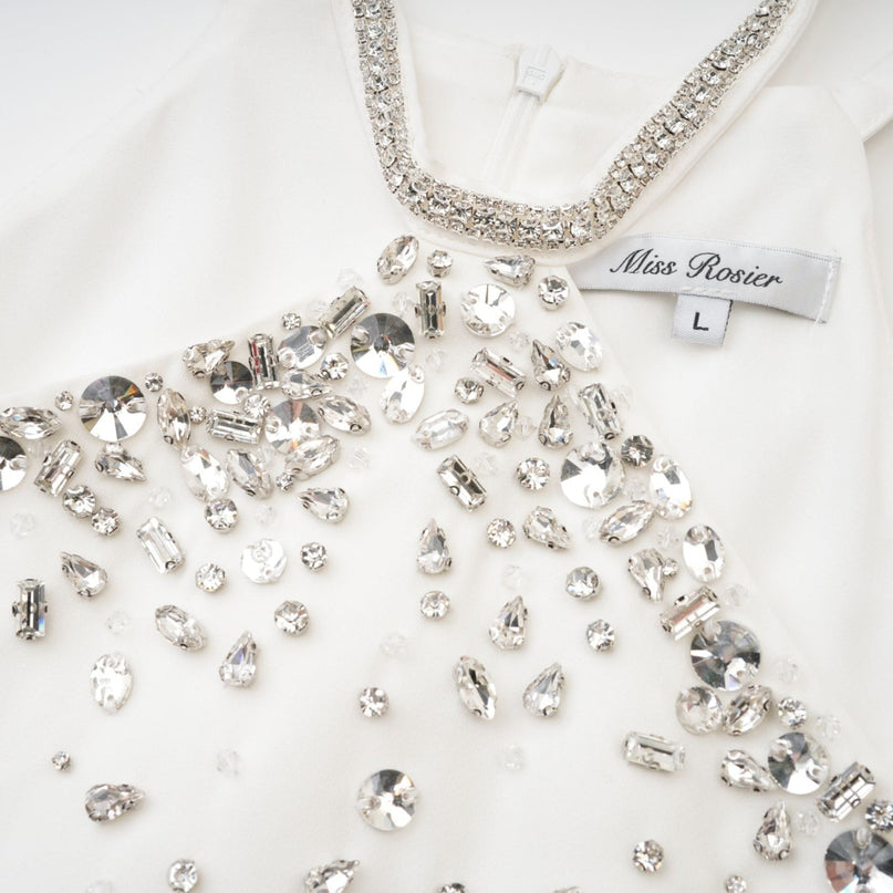 White ornate Xanthea mini dress with decorative details